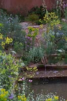 Water rill leading into a stepped gravel pool. The M and G Garden, Sponsor: M and G Investments, RHS Chelsea Flower Show, 2018.