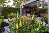 Modern pavillion with a water rill and soft planting. The LG Eco-City Garden, Sponsor LG Electronics, RHS Chelsea Flower Show, 2018.