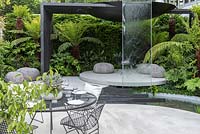 Water feature and dining area. VTB Capital Garden - Spirit of Cornwall, RHS Chelsea Flower Show, 2018. Sponsor: VTB Capital