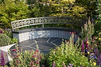 Semi-circular garden seat in The CHERUB HIV Garden: A Life Without Walls, Sponsor: CHERUB - RHS Chelsea Flower Show, 2018.
