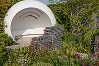 Space to Grow Garden - The CHERUB HIV Garden: A Life Without Walls - white pod representing a clinic, mixed planting and broken walls - Sponsor: CHERUB - RHS Chelsea Flower Show 2018