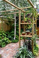 London patio garden with pergola, wooden garden office and mixed planting