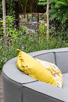 Grey outdoor sofa arrangement with yellow cushions