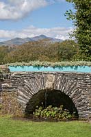 The Cnicht seen from the Garden at Plas Brondanw. Rock - and water-feature known as the 'Full-stop' 
