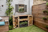 Courtyard garden in West London with brick barbecue, wall mirror and Cedar battened Trellis