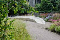 The Garden of Reflection features a grove of 85 silver birch trees, a 40' long 
stone seat inscribed with the words 'Wanderer, there is no path, the path is 
made by walking', and a border of late summer herbaceous perennials and grasses