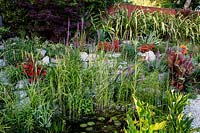 Rockery and pond  Pam Woodall's garden, 'Pinecombe' in Dorset, UK