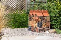 Insect hotel created in wire gabion with different building and dried plant materials
