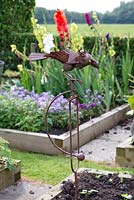 Metal crow ornament to scare off the other birds in the vegatable and cutting garden. 