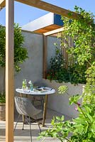 Wooden pergola with table and chair - 'The Urban Escape', RHS Malvern Spring Festival, 2018.