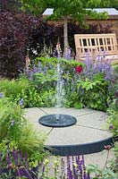 Circular fountain in show garden - 'A Family Garden', sponsored by CCLA, RHS Chatsworth Flower Show, 2018.

