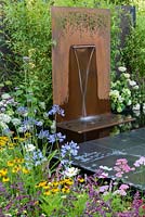 Modern water feature in show garden - Brilliance in Bloom, Sponsored by Stark and Greensmith, Simon Probyn Sculpture, Nickie Bonn and Art4Space, RHS Hampton Court Flower Show, 2018.