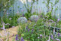Wooden boards with seating area and perennials. Southend Young Offenders 'A Place to Think, RHS Hampton Flower Show, 2018 