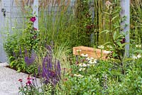Wooden bench surrounded by perennials - Secured by Design, Sponsored by Secured By Design, Capel Manor College, Smartwater, RHS Hampton Court Flower Show, 2018.