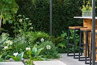 Bar with stools and Ferns, Agapanthus and Fatsia. 'Landform Garden Bar', RHS Hampton Flower Show, 2018
