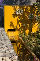 Envelope water feature in yellow wall - Santa Rita 'Living La Vida 120' Garden, Sponsored by Santa Rita Wines, RHS Hampton Court Flower Show, 2018.