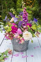 Mixed summer garden flowers in enamel pail. 
