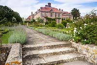 View to lavender lined path leading past box parterres, to house. Heale House, Middle Woodford, Salisbury, Wilts, UK. 