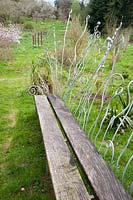 Decorative metalwork bench. Moors Meadow Garden and Nursery, Bromyard, Herefordshire, UK. 