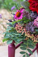 Details of floral arrangement on chair - including Sorbus, Yew, Sorbus and Echinacea. 