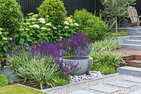 View of modern flowerbed with water bowl. 