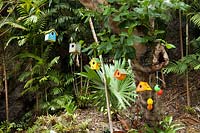 Colourful bird boxes in tropical garden