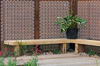 Timber seat with Corten steel fencing panels. Finding Urban Nature Garden, RHS Tatton Park 