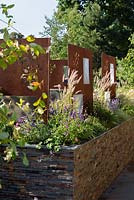 Stenciled and laser cut corten steel panels. RNIB's Community Garden, RHS Hampton Court