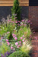 View along flowerbed in show garden. A Place To Ponder Garden, RHS Tatton Park Flower Show, 2018. 