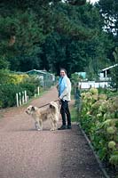 Yolanda van Velsen and her dog Sunny walking in the garden