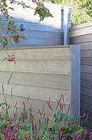 Persicaria and Malus floribunda in front of new wooden shed.