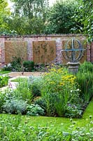 Armillary Sundial in mixed bed. Garden Design by Peter Reader Landscapes.
