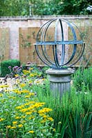Armillary Sundial in mixed bed. Garden Design by Peter Reader Landscapes.
