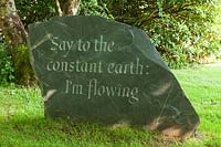 Slate stone carved with quotation from the poet Rilke. Plaz Metaxu Garden, Devon, UK.