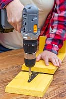 Drilling hinge fastening onto wood to create hinged lid