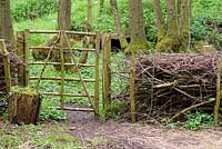 Gate in 'fedge' - a fence and hedge made using wood cuttings, Ross-on-Wye, Herefordshire