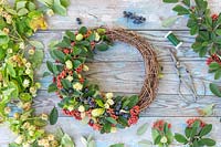 Autumnal deocrative wreath, with hop flowers, Cotoneaster and sloes.