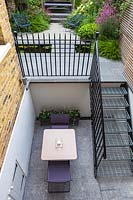 Overview of metal staircase and small urban garden. Garden designed by John Davies Landscape.