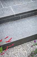 Steps in hard wearing black basalt tiles. Garden Design by John Davies.