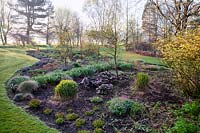 Early spring growth on perennials and grasses at Foggy Bottom Garden, Bressingham Gardens, Norfolk, UK.  Designed by Adrian Bloom.