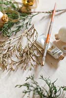 Painting foliage gold, with ribbons and baubles