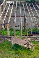 Disused Greenhouses with ancient wheelbarrow. Trevarno Estate, Cornwall, UK.