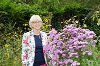 Helen Mount surrounded by some of the HPS Conservation Scheme Plants, namely Aster novi-belgii 'Farncombe Lilac' and an unidentified Helianthus