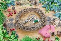 Tools and materials to make decorative Christmas wreath.