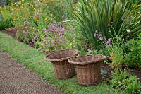 Two wicker baskets used for collecting weeds and cuttings in. Palheiro's Garden, Blandy's Garden, Funchal, Madeira. 
