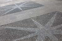 Decorative star-shaped in paving made with cobblestones 