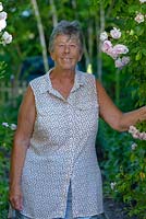 Shirley Shadford, the owner of Clover Cottge with Rosa 'Blush Noisette'.