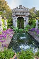 Italianate water fountains and pool with Alliums 