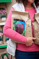 Woman buying tulip bulbs at a garden centre. 