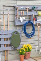 Pallet storage organiser, split painted pallet used for storing tools and gardening equipment. 